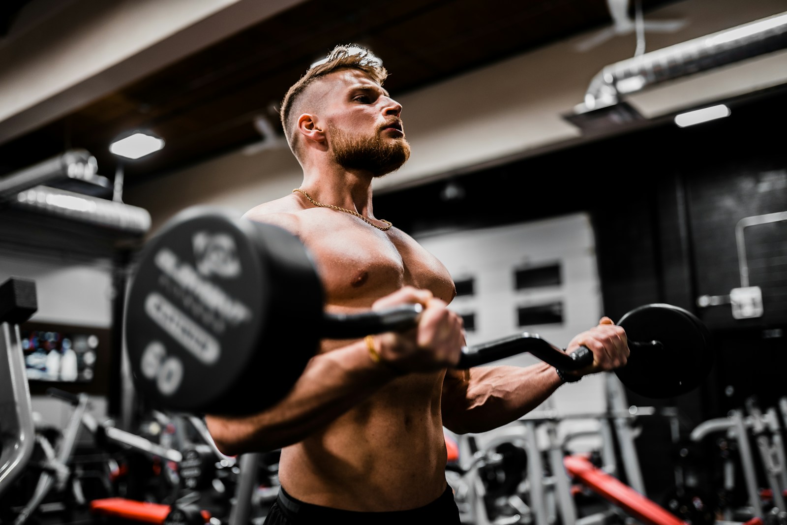 Man performing a strength training workout with dumbbells for muscle building.